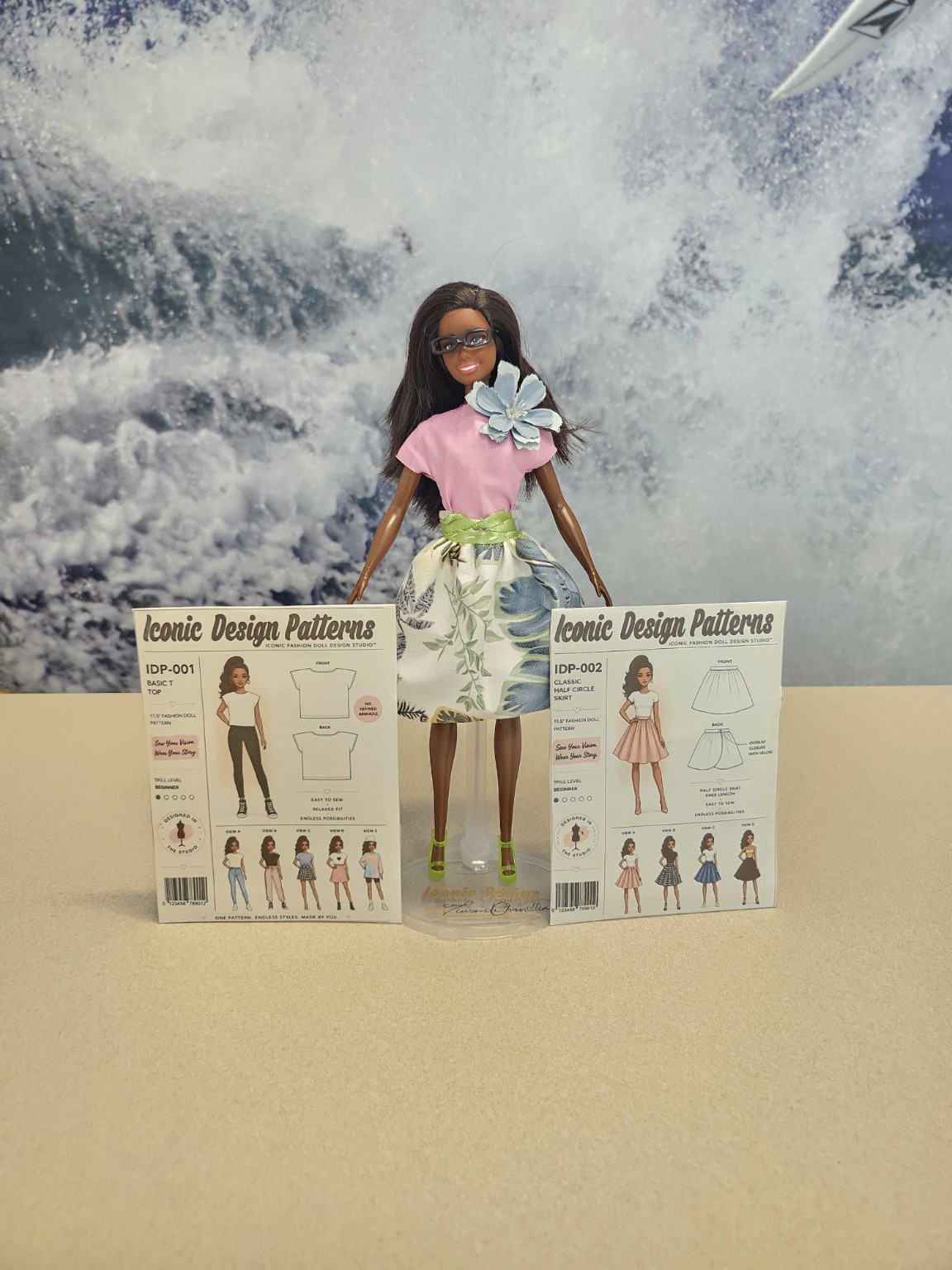 Fashion doll wearing a pink top and floral skirt beside Iconic Design Patterns